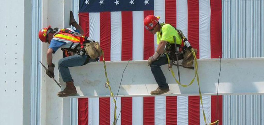 Two CCB employees working over an American flag