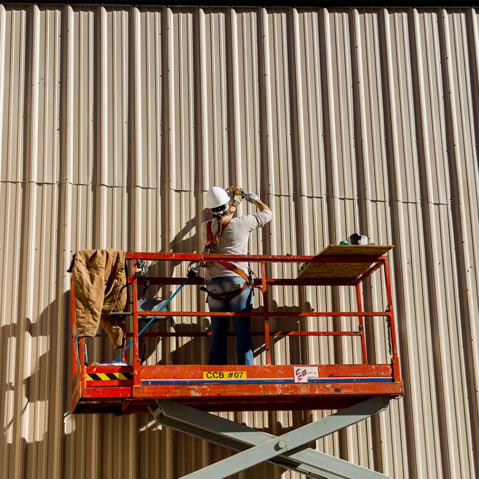 A CCB employee on scaffolding