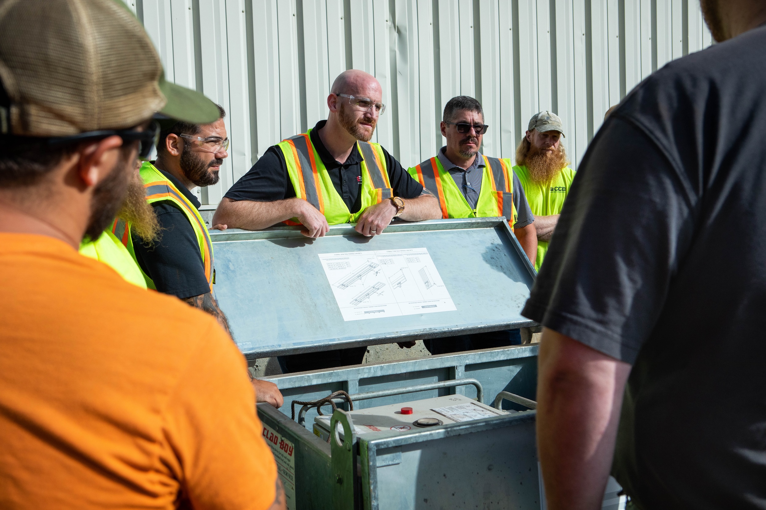 An employee showing other employees a diagram