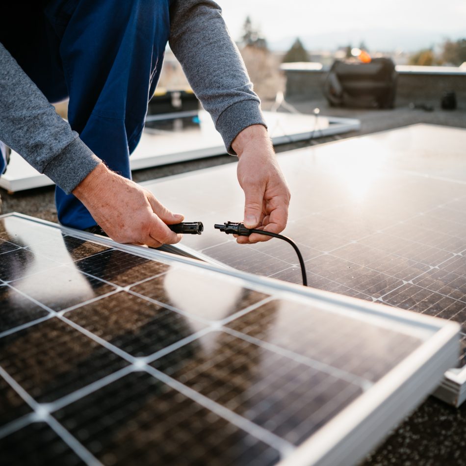 A worker connecting a solar panel