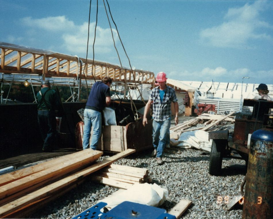 Two workers on a construction site in the 80's