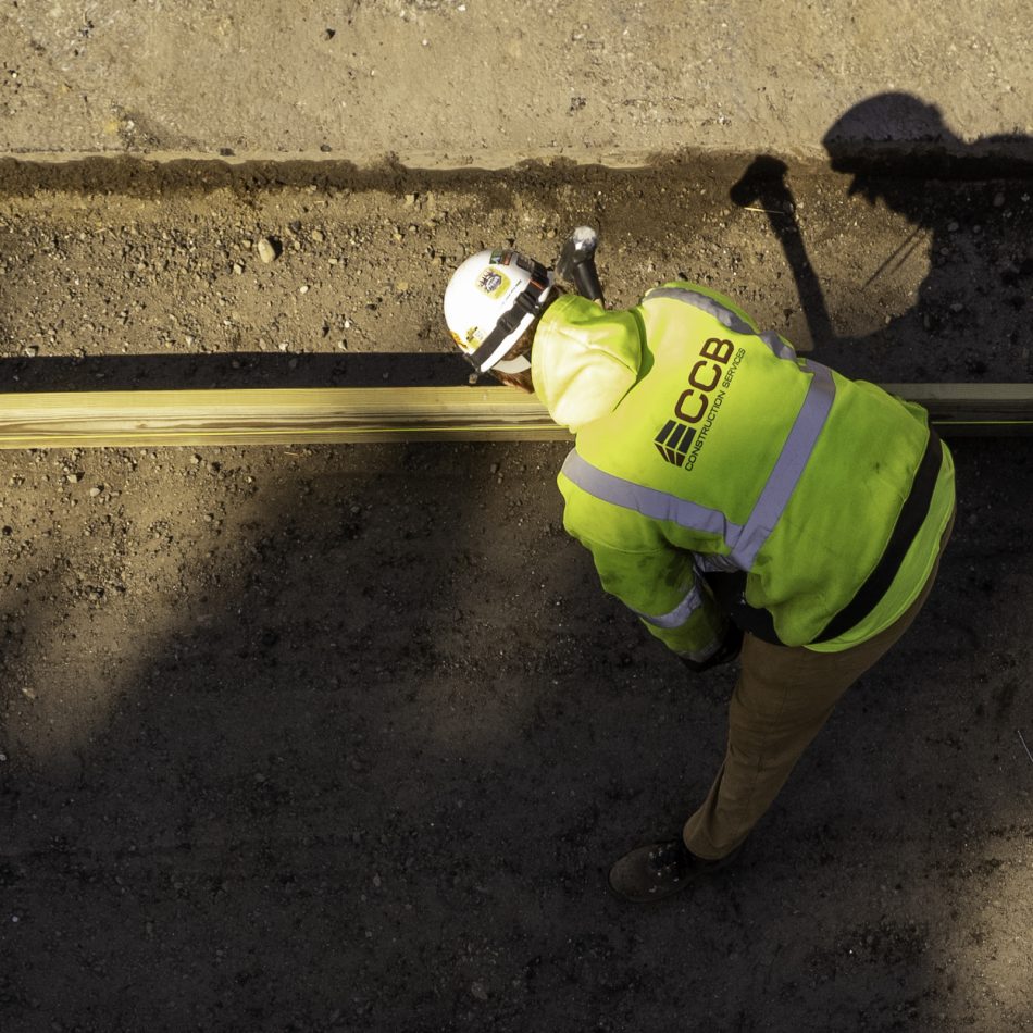 A worker laying down framing for a project