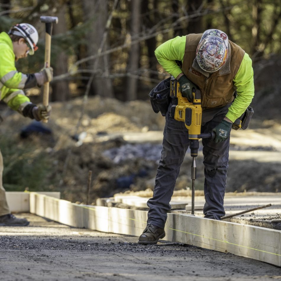 Workers on site laying down framing for a project