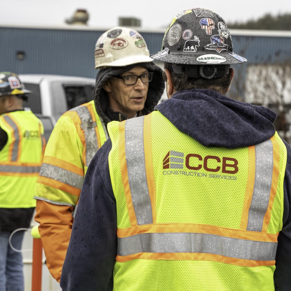 A worker receiving instructions on-site from another worker