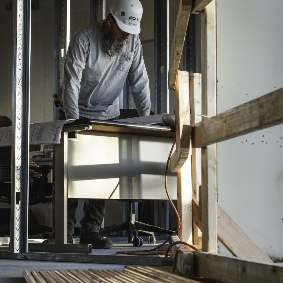 A worker reviewing building plans