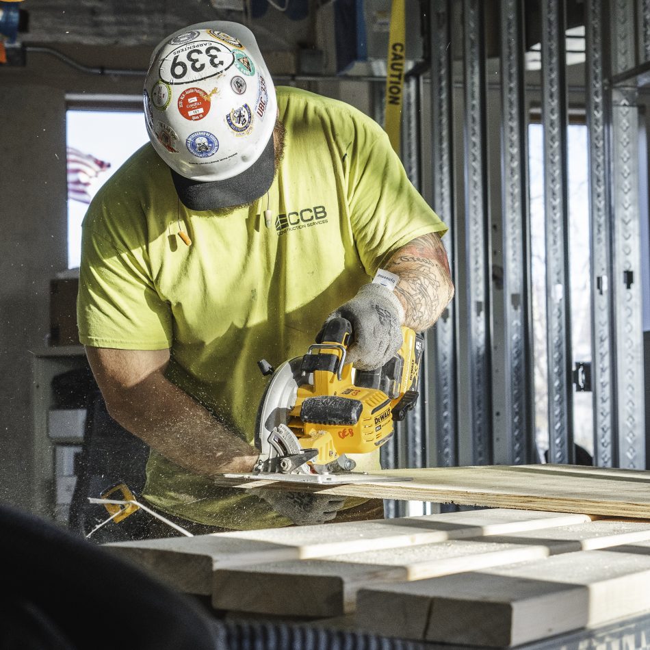 A worker cutting wood