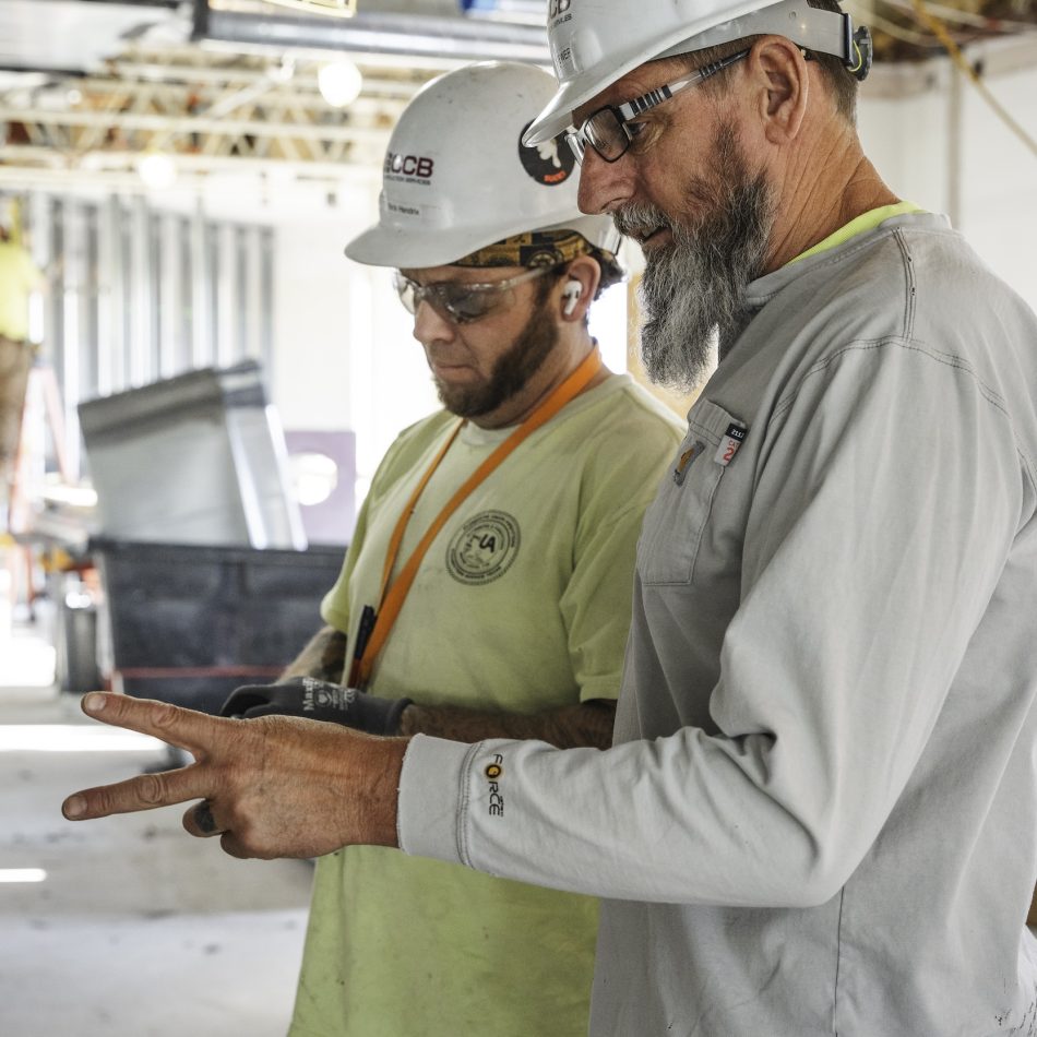 A construction worker receiving instructions from another worker