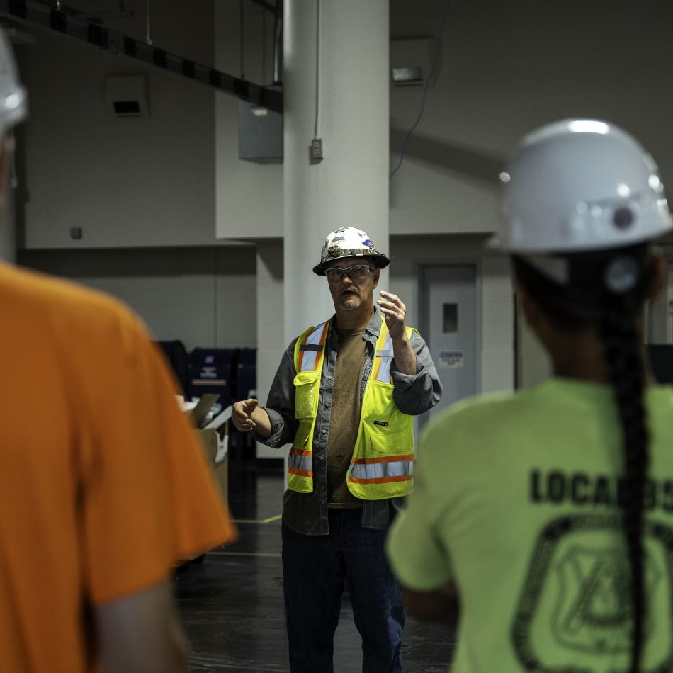 A CCB employee addressing a group of people